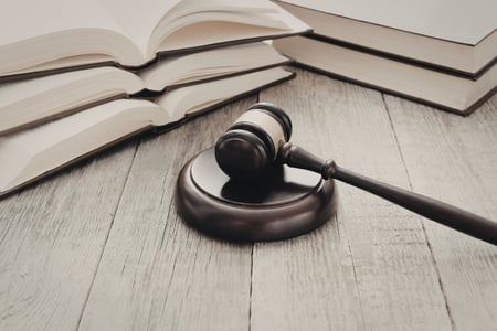 wooden gavel next to open law books
