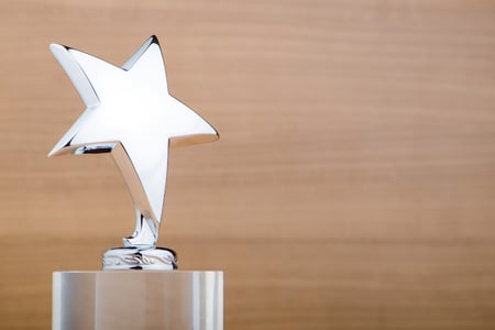 silver star trophy with wood background