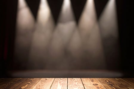 spotlights shining with black background and wooden floor
