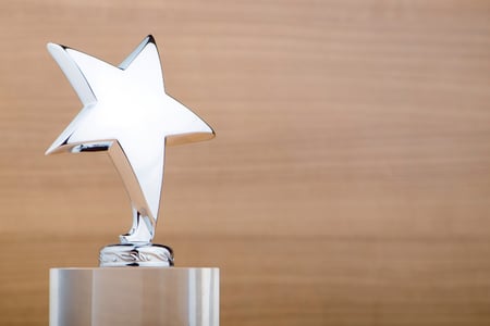 silver star trophy on wood background