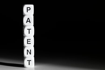 cubes that spell patent, black background