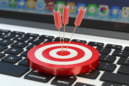 darts on a target on top of a keyboard
